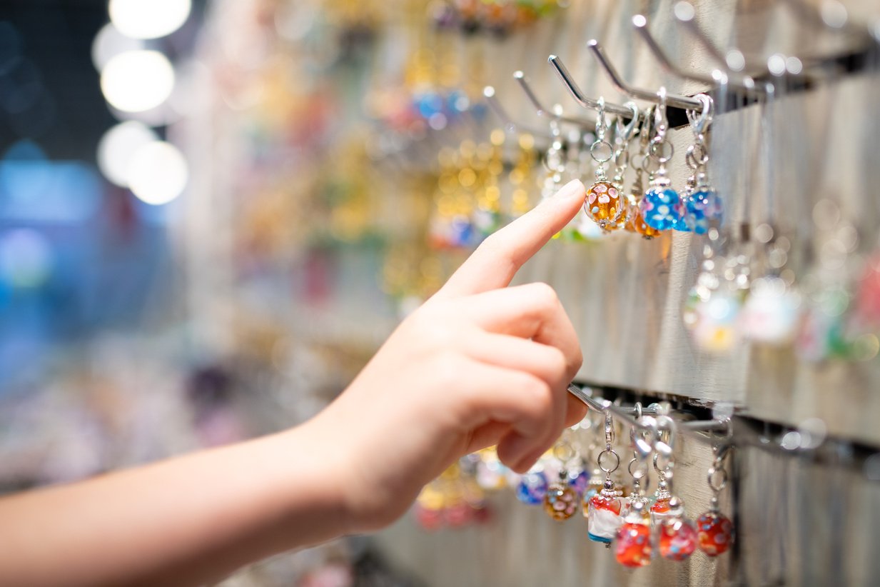 Child's hand choosing glass miscellaneous goods